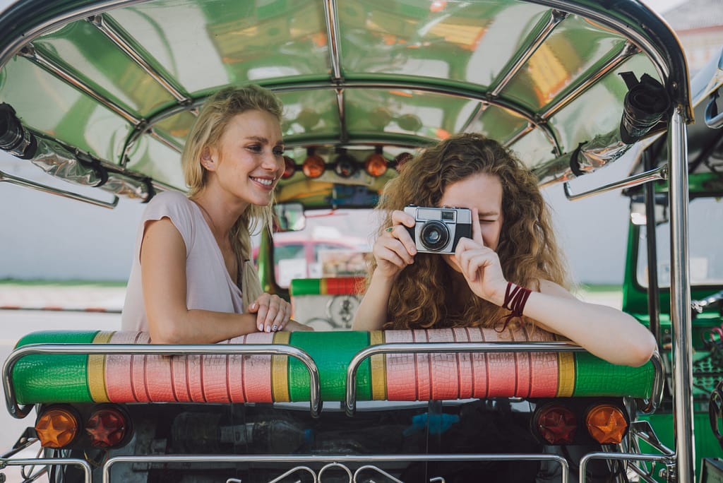 Couple of beautiful girls visiting bangkok maining attractions